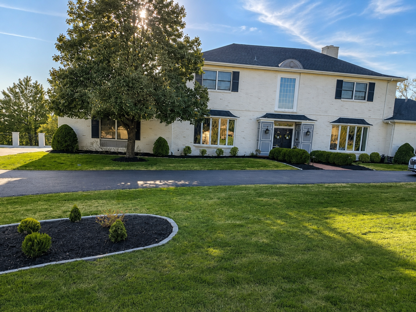 Clean finished landscaping result at brick house